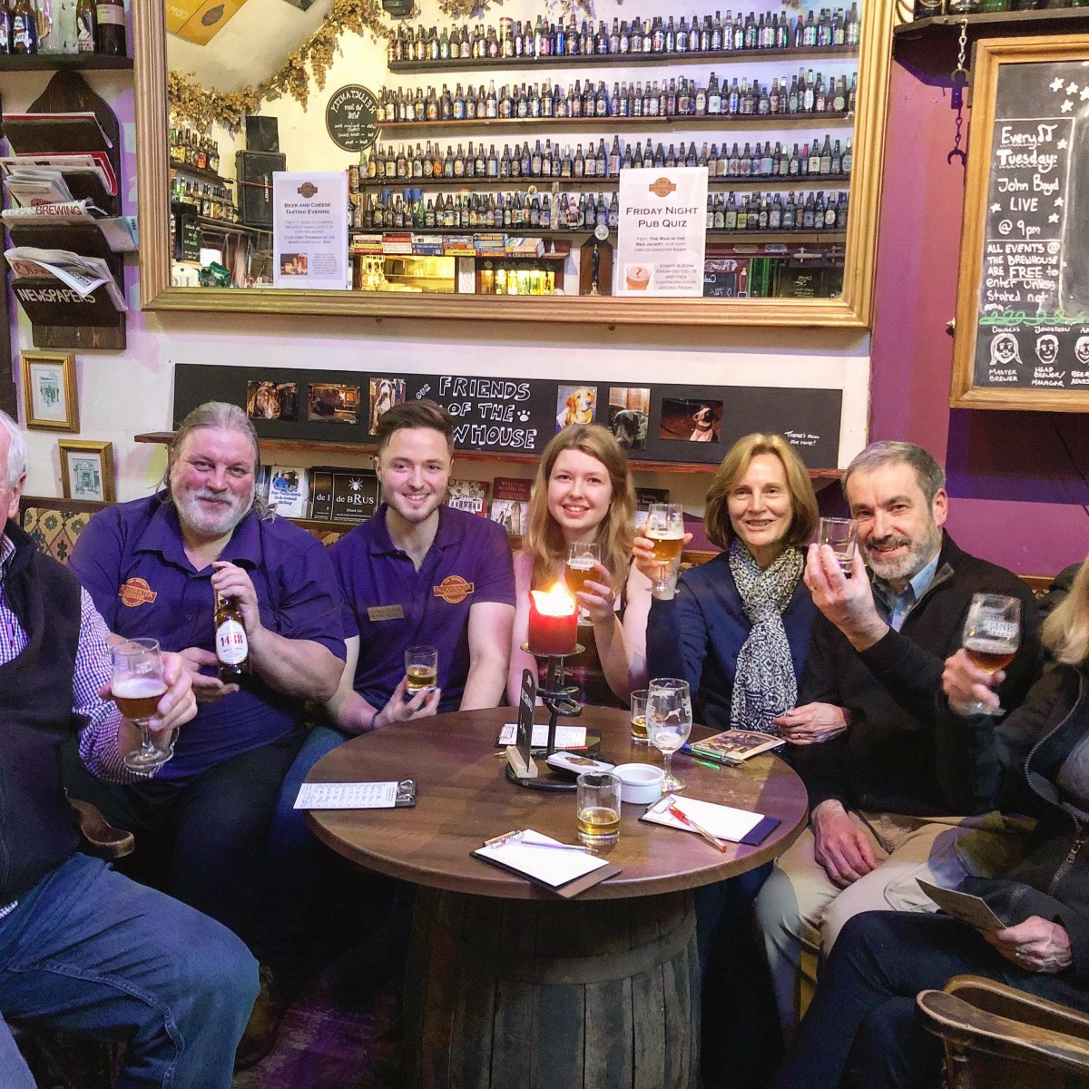 people sitting at a table posing for the camera