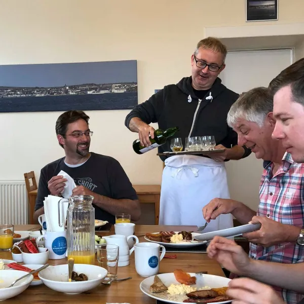 a group of people sitting at a table with a plate of food