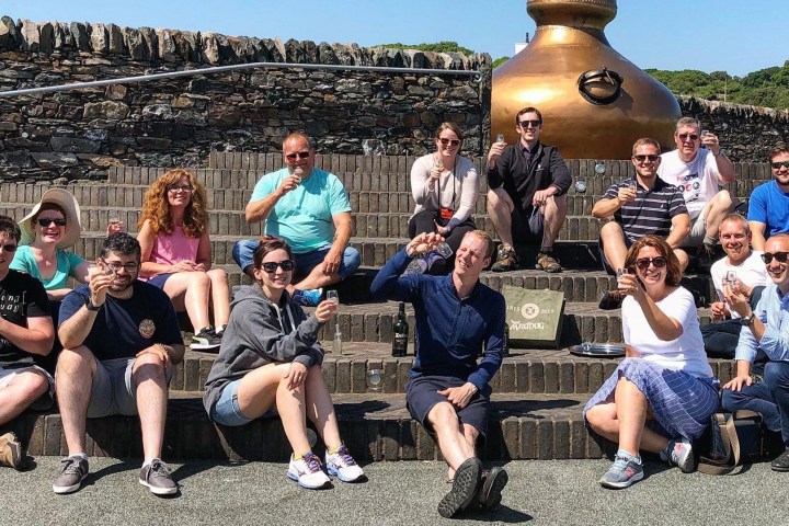 people showing their glasses of whisky