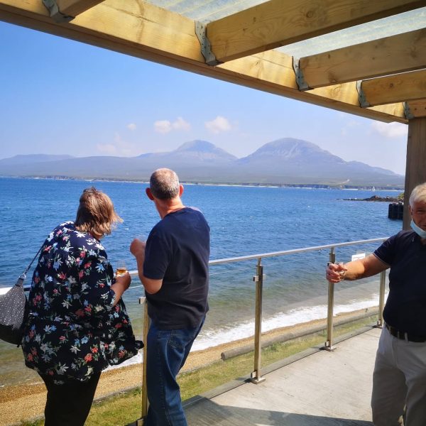 a group of people standing on a bridge over a body of water