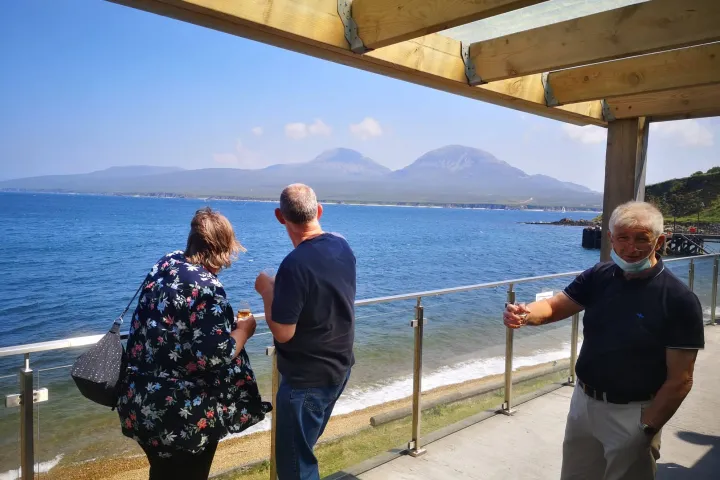 a group of people standing on a bridge over a body of water