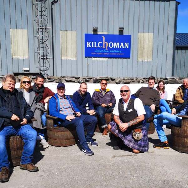 a group of people sitting in front of a building