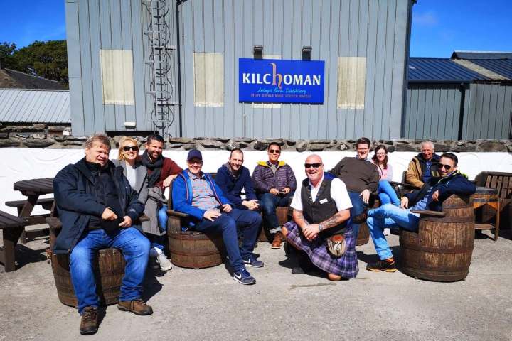 a group of people sitting in front of a building