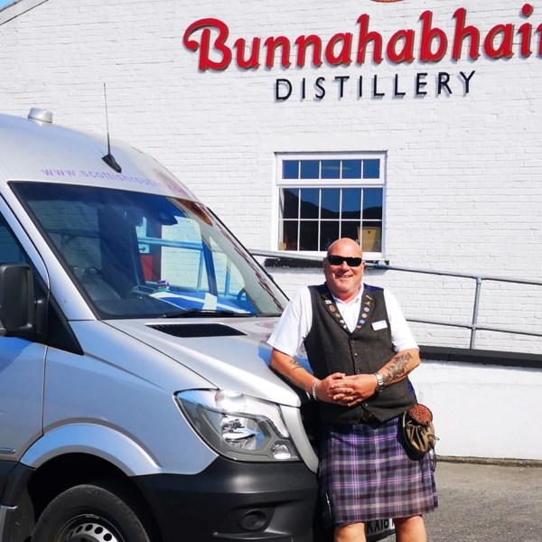 a person standing in front of a car posing for the camera