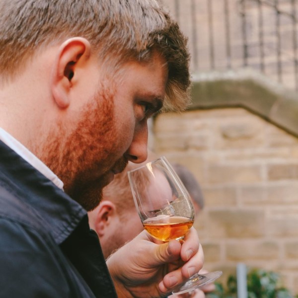 a person drinking from a wine glass