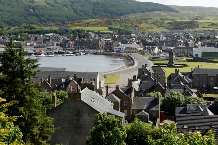 a bridge over a body of water with a mountain in the background