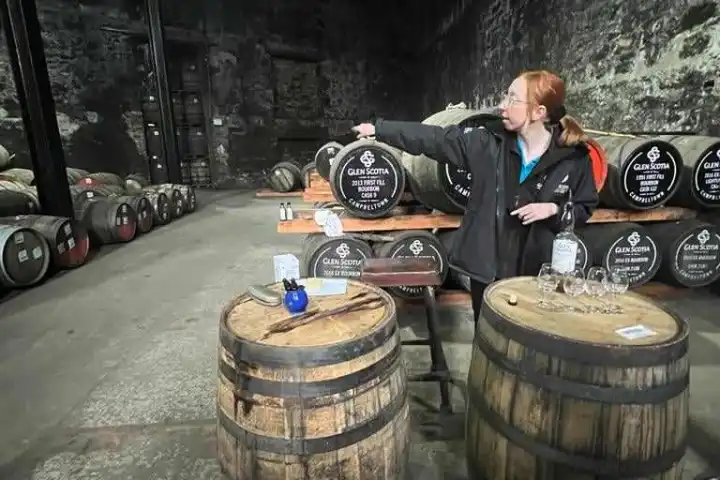 a man standing in front of a barrel