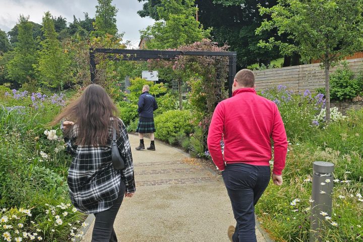 a group of people standing in a garden