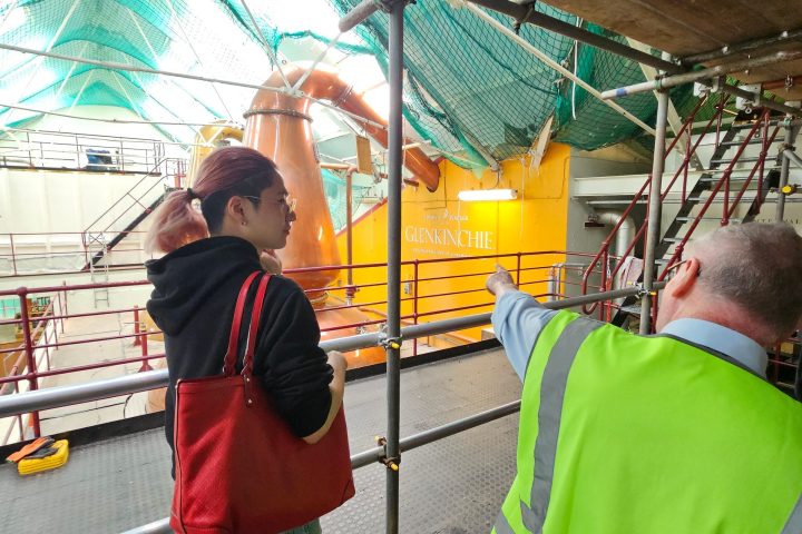 a man and a woman standing in front of a building