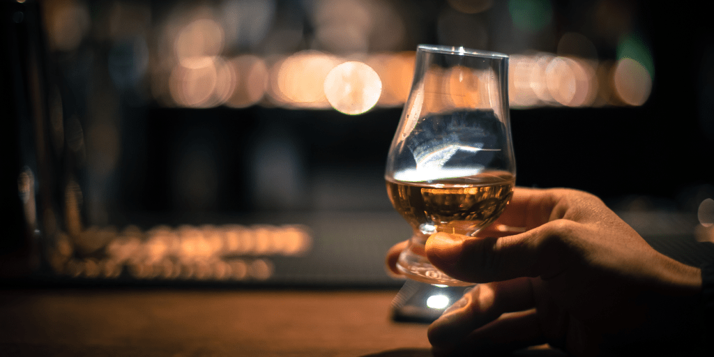 a hand holding a glass of wine